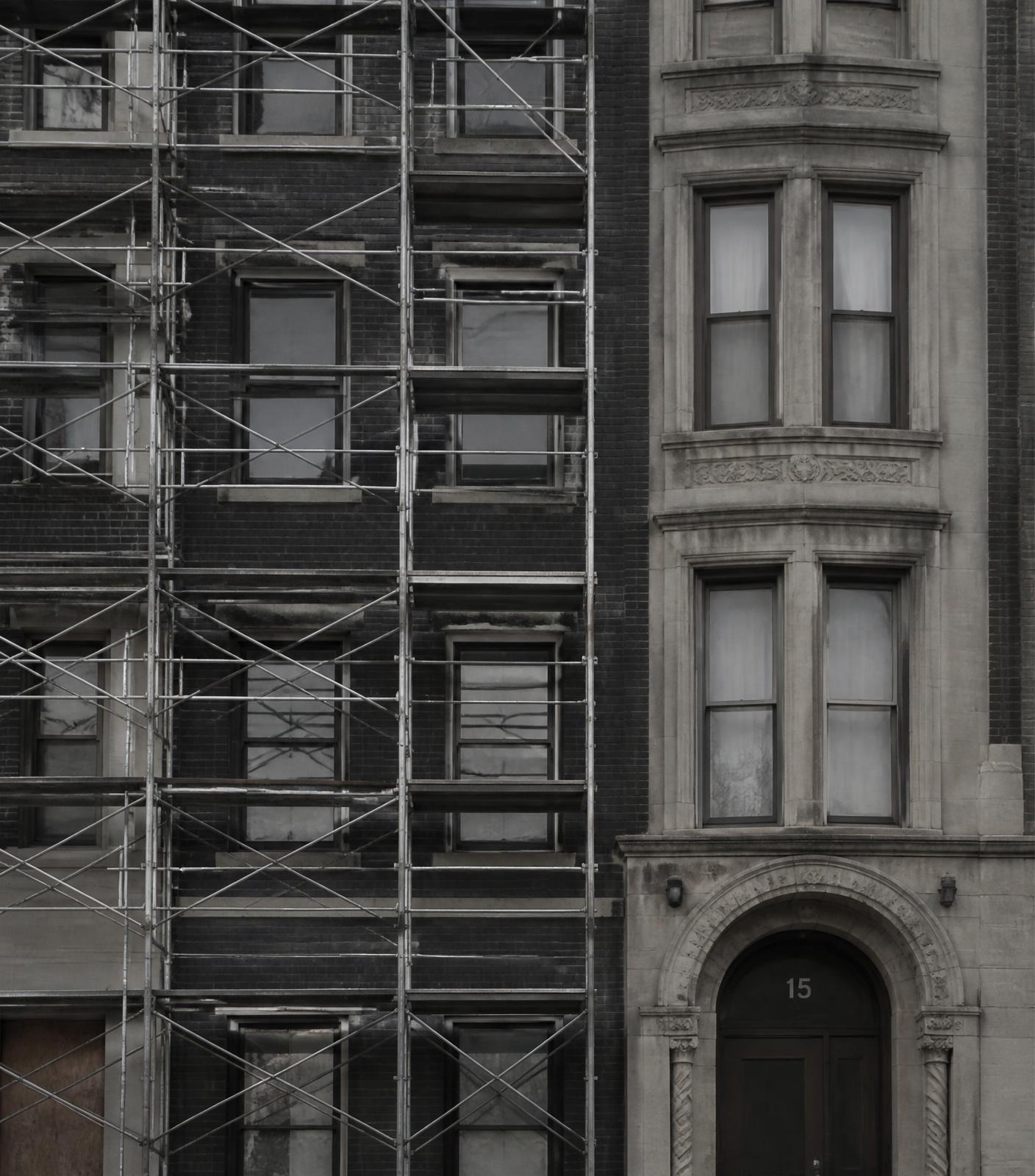 Brick and stone multifamily building facade under renovation